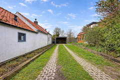 Rustieke oprit tussen oude huizen.png